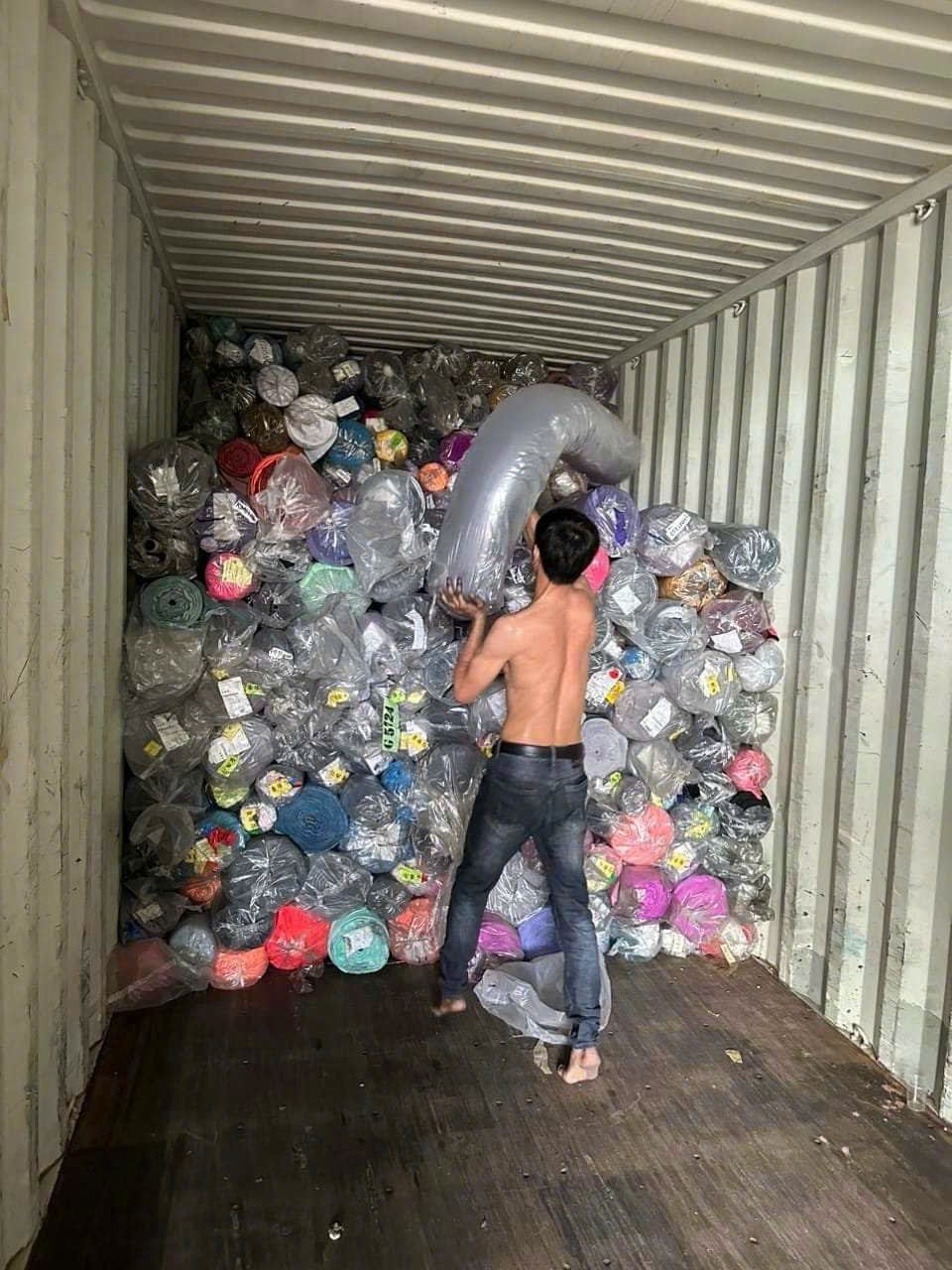Stock fabric rolls being loaded into a container